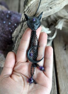 Black cat miniature and crescent sailor moon are made of a kind of resin. they are Painted black in hand. All miniatures and molds are sculpted / made by Umay Designs. Amethyst Beads are 6 - 8 - 10 mm sizes as dangled on copper chains under the moon. This item is ships with a black cord or copper chain 18 inches (45 cm) in a box. I use copper closures for the black cord/chain. This model would be made as earrings also. Worldwide express cargo service by UPS, signature required delivery. Thank you! Bohemian Style Jewelry, Art Miniature, Wearable Art Jewelry, Witch Jewelry, Celestial Necklace, Cat Pendant, Under The Moon, Unusual Jewelry, Art Resin