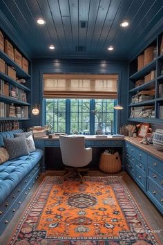 an office with blue walls and built in bookshelves is pictured here, along with a rug on the floor