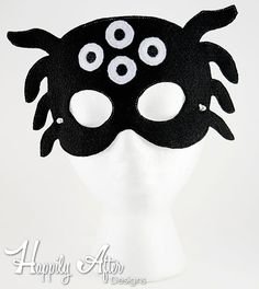 a black and white mask with googly eyes