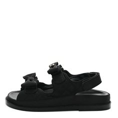 This is an authentic pair of CHANEL Grosgrain Quilted Bow Dad Sandals size 37 in Black. These stylish sandals are crafted of black grosgrain fabric. These sandals feature velcro ankle straps and bows with CC logos. Dad Sandals, Stylish Sandals, Ankle Straps, Chanel, Sandals, Fabric, Black, Ankle Strap, Logos