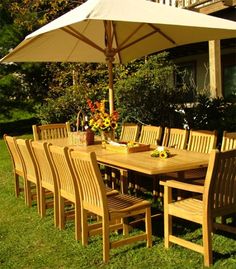 an outdoor dining table and chairs with umbrella