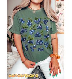 Treat yourself to this adorable Cute Blueberry Tshirt perfect for summer days! Printed on the trendy and loved by many Comfort Colors t-shirts, our Cottagecore Blueberry Shirt is oversized and so cozy, you'll never want to take it off. The Blueberry Print Tee features vintage styled blueberry clusters in a random pattern.  Embrace your love for all things cute and fruity with this Blueberry Tshirt!  It will be your most favorite summer tee! 🫐 💙 COMFORT COLORS 1717 Comfort Colors 1717 Unisex sh Summer Cotton Tops With Plant Print, Cotton Tops With Plant Print For Summer, Blue Cotton T-shirt For Summer, Cute Summer Tops With Plant Print, Spring Cotton Tops With Fruit Print, Cotton Fruit Print Tops For Spring, Trendy Blue Floral Print T-shirt, Cotton Tops With Fruit Print For Spring, Blue Plant Print Crew Neck Top