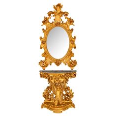 an ornately carved mirror with a shelf underneath it