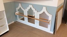 a kitchen with blue walls and white trim