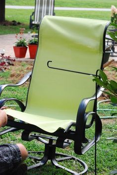 a person sitting in a lawn chair on the grass