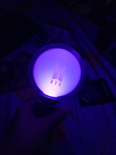 a person is holding a lit up device in their hand, with the word bt's on it