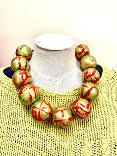 quite large wood beads- all hand painted in layers of color- golds and reds and under colors of white and cream.  I do varnish the beads to protect the design and the paint. I see these large beads as elegant, dressy and bold.  Do you need it lengthened? These wood beads are NOT heavy and sit beautifully on the neck. An original necklace.  I like these with browns and other fall colors. Also with black and white! Free shipping within the continental USA Bohemian Hand Painted Brown Necklace, Bohemian Brown Hand Painted Necklace, Artisan Red Necklace With Wooden Beads, Multicolor Wooden Oval Beads Necklace, Multi-strand Red Necklace With Wooden Beads, Original Necklace, Chunky Bead Necklaces, Wood Bead Necklace, Chunky Beads