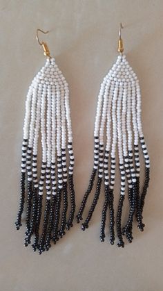 African beaded earrings, Handmade earrings, African jewelry, Maasai jewelry, Earrings for women,Gift for her, Tribal EarringsThese stunning earring are superbly crafted which will absolutely makes stand out in any occasion.Color - White and Black.3-5 days delivery via DHL ExpressThe shipping fee is for the first item only and additional necklaces or items ship for free.Wholesale available at a fair price,please contact me.For any clarification,please send me a convo or an e-mail.Thank you for vi Traditional Beaded Earrings With Round Beads, Traditional Beaded Dangle Hoop Earrings, White Dangling Hoop Earrings With Colorful Beads, White Dangle Hoop Earrings With Colorful Beads, Gift White Beaded Earrings With Black Beads, Traditional White Hoop Earrings With Ear Wire, White Beaded Earrings With Black Beads, Bohemian White Earrings With Black Beads, White Dangle Jewelry With Black Beads