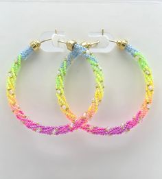 You will love these handmade, eye-catching Rainbow Ombre Earrings. Featuring a striking arrangement of neon glass beads along with moonstones on 14k Gold Filled Hoops, these earrings are sure to bring joy to anyone who wears them.  14K Gold-Filled  Miyuki Glass Moonstones Length approx 1.8 inches UV (Blacklight) Reactive Unique Multicolor Small Hoop Jewelry, Unique Multicolor Hoop Jewelry, Handmade Colorful Hoop Jewelry, Colorful Handmade Small Hoop Jewelry, Colorful Handmade Hoop Jewelry, Multicolor Hoop Jewelry For Party, Trendy Rainbow Hoop Jewelry, Trendy Colorful Hoop Jewelry, Colorful Beads Jewelry Gift