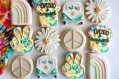 decorated cookies with peace signs, flowers, and hippies are arranged on a table