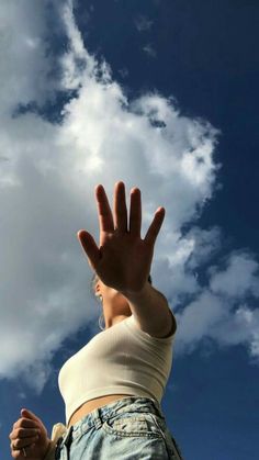 a woman with her hand up in the air