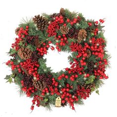 a christmas wreath with red berries and pine cones