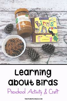 the words learning about birds are displayed next to pine cones and other items on a wooden table