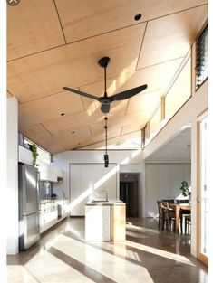 a ceiling fan is hanging from the ceiling in a kitchen