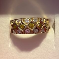 a yellow and white diamond ring sitting on top of a box