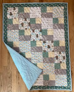 a quilted table runner on the floor with a blue napkin in front of it