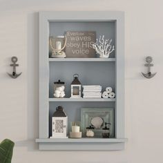 a shelf with several items on it and an anchor wall hook in the corner next to it