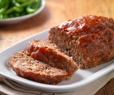 meatloaf on a white platter with ketchup