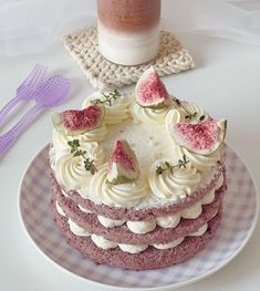 a cake with white frosting and watermelon slices is on a purple plate