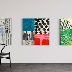 three paintings hang on the wall next to a chair