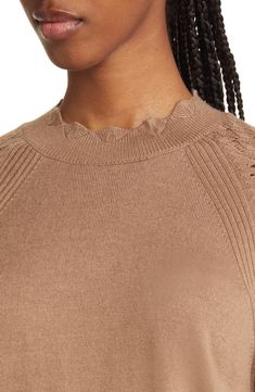 This woolly mock-neck sweater is knit with scalloped edges and pointelle-stitched sleeves. 24" length Mock neck Long sleeves 45% acrylic, 45% nylon, 10% wool Machine wash, line dry Imported Spring Turtleneck Sweater In Pointelle Knit, Spring Turtleneck Sweater With Pointelle Knit, Elegant Solid Color Pointelle Knit Sweater, Elegant Pointelle Knit Sweater, Turtleneck Pointelle Sweater, Turtleneck Pointelle Knit Sweater, Pointelle Knit Turtleneck Sweater, Stretch Turtleneck Sweater With Pointelle Knit, Scalloped Edges