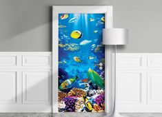 an open door to the underwater world with fish and corals on it, in front of a white wall