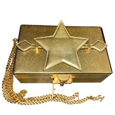 Oscar De La Renta Alibi Lam Leather Star Handle Box Clutch Worn By Beyonce On September 12, 2021 In Portofino ***Can Be Worn As A Clutch Or Shoulder Handbag On A Chain** Structured Minaudire With Utilitarian Hardware Removable Shoulder Chain Top Handle Top Flap With Clasp Closure Goldtone Hardware 1 Interior Compartment Interior Card Slot Leather Trim: Brass Made In Italy Size Height: 4.75" Width: 7.75" Depth: 2.25 This Is A Sample *****One Of One***** This One Has The Star On The Handle (Pictur High-end Gold Shoulder Bag As Gift, Designer Gold Rectangular Case Shoulder Bag, Evening Clutch With Rectangular Case, Formal Top Handle Evening Bag With Original Box, Luxury Gold Rectangular Case Box Bag, Designer Gold Rectangular Case Bag, Luxury Gold Rectangular Box Bag, Top Handle Clutch With Original Box As Gift, High-end Gold Crossbody Box Bag