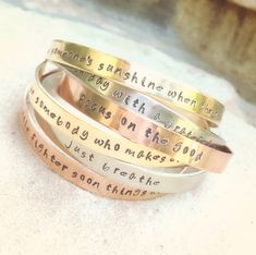 four different types of bracelets with words engraved on the sides and names in gold, silver or rose gold