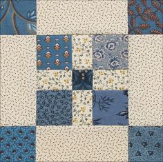 a blue and white patchwork quilt with different designs on the front, back and sides