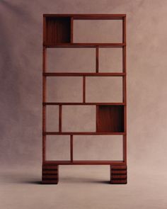 a wooden book shelf with multiple compartments on each side and one section missing from the top