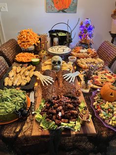 a table full of food and decorations for halloween