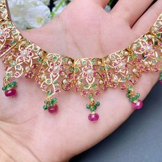 Featuring a beautifully carved necklace set in 22ct gold embellished with rubies emeralds and pearls. The necklace weighs 42.85 GMs including 4.92 GMs of hanging ruby emerald beads The earrings weigh 8.80 GMs including 0.72 GMs of hanging ruby emerald beads Price Breakup Summary Component Rupees % of Total 22k Gold 229,747 78.3% Stones & Beads 13,891 4.7% Making Charges 41,355 14.1% Taxes (GST) 8,550 3.0% Total 293,542 100.0% View Detailed Price Breakup Watch Video Here 22k Gold Temple Jewelry Emerald Necklace For Celebration, 22k Gold Emerald Temple Necklace For Festive Occasions, Green Ruby Necklace For Celebrations, Festive 22k Gold Emerald Necklace For Celebration, Festive Jeweled Ruby Necklaces, Festive Ruby Jeweled Necklaces, Festive Yellow Gold Emerald Necklace For Celebration, 22k Gold Green Necklace With Intricate Design, Green 22k Gold Necklaces With Tilla Detailing