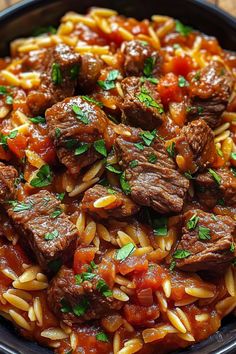 a bowl full of pasta with meat and tomato sauce