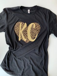 Glitter KC Cheetah heart tee. Can be customized with different fabric and colors! Cute Kansas City t Black Cotton T-shirt With Glitter Print, Black Cotton Top With Glitter Print, Cute Cotton T-shirt With Glitter Print, Short Sleeve Cotton T-shirt With Glitter Print, Cute Crew Neck Top With Glitter Print, Cotton Short Sleeve T-shirt With Glitter Print, Glitter Print Cotton T-shirt, Fitted Glitter Print Cotton Top, Fitted Cotton Top With Glitter Print