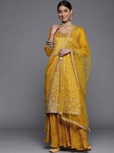 PRODUCT DETAILS  Mustard yellow embroidered Kurta with Sharara & dupatta Kurta design: Floral embroidered Straight shape Regular style Round neck, three-quarter regular sleeves Sequinned detail Calf length with scalloped hem Silk blend machine weave fabric Sharara design: Solid Sharara Partially elasticated waistband Slip-on closure 2 pocket Dupatta: Solid Tasselled border Size & Fit The model (height 5'8) is wearing a size S Dupatta: 2.7 x 1.1 meters (length x width) Material & Care Kurta: Silk Blend Bottom: Silk Blend Dupatta: Silk Blend Dry Clean Specifications Sleeve Length : Three-Quarter Sleeves Top Shape : Straight Top Type : Kurta Bottom Type : Sharara Dupatta : With Dupatta Top Pattern : Embroidered Top Design Styling : Regular Top Hemline : Scalloped Top Length : Calf Length Neck Yellow Sharara, Sharara Dress, Kurta With Sharara, Embroidered Top Designs, Sharara Designs, Sharara Pants, Kurta Sharara, Partywear Dresses, Three Quarter Sleeve Tops