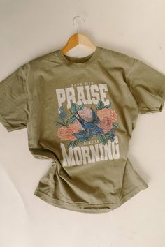 Making His praises bloom, with our "Sing His Praise Each Morning" tee. This vibrant design features our hand-drawn florals and our whimsical birdie. 100% Ring-spun Cotton. Garment-dyed for that vintage, faded look and almost no shrinkage at home Relaxed fit -Spring / Floral/ Bloom -Faith Based - Trendy Graphic Tees - Hand drawn graphics Trending Tshirt Design Ideas, Godly Shirts, Graphic Tee Ideas, Cute T Shirt Designs, Indie Wardrobe, Christian Asthetic, Cute Christian Shirts, Christian Boutique, Etsy Shirts