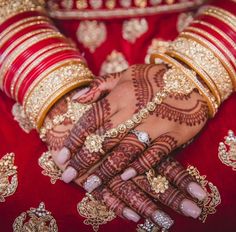 a woman's hands with henna and bracelets