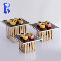 four pieces of cake sitting on top of wooden tables