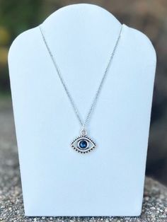 Swarovski crystal evil eye necklace. Charm is antique silver plated and measures 15x16mm. Stainless steel cable chain measures 18in in length. Evil eye necklaces are believed to protect the wearer from negativity directed towards them. Silver Metal Jewelry With Evil Eye, Silver Evil Eye Charm Necklace With Round Pendant, Silver Charm Necklace With Evil Eye Pendant, Silver Metal Evil Eye Jewelry, Silver Necklace With Evil Eye Round Pendant, Silver Sterling Silver Evil Eye Necklace, Silver Evil Eye Pendant Necklace, Silver Evil Eye Round Pendant Necklace, Adjustable Silver Evil Eye Necklace