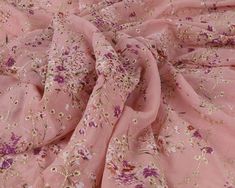 the fabric is pink with flowers on it