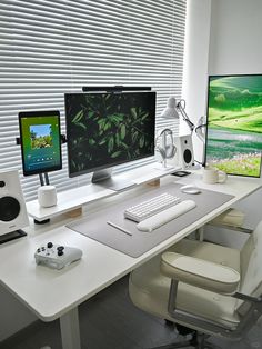 a white desk with two monitors and a keyboard