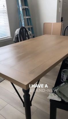 a table that is in the middle of a room with some chairs and ladders