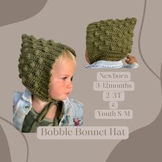 a baby wearing a crocheted hat and looking down at the side of it