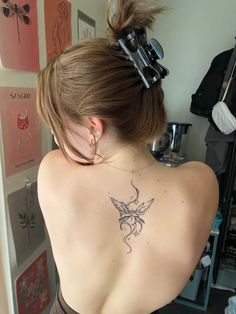 a woman with a tattoo on her back