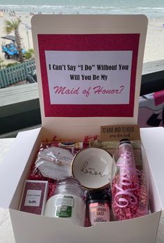 a box filled with lots of different items on top of a table next to the ocean