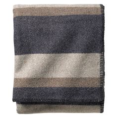 a gray and black striped blanket on a white background