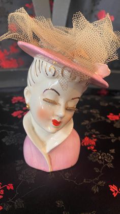 Vintage Lady Head Vase with Pink Hat and Dress, Porcelain Vase Planter. Marked japan. Great condition RARE Vase within Hat has a potporri veil bag inside. Can be taken out   Dimensions: 4 inches tall and 2.5 wide Ceramic Lady Heads, High Collar Dress, Head Vases, Rocky River, Head Planters, Vintage Lady, Head Vase, Pink Hat, Gold Accent