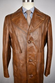 "More pictures at http://revive-clothiers.com/products/3620 Free Shipping on All Domestic Orders! Internal Sku: 60760 Product Details: Manufacturer Country:United States Manufacturer Date:1970's Brand:Grais Material:100% Leather Color:Light Brown Pattern:Solid Buttons:Three Vents:Single Lining:Zip Out 3/4 Lining Condition:Item is in good condition. It is ready to wear and does not have any flaws. It shows normal signs of wear. Middle button a little loose. Missing half of the front belt. Product Formal Long Leather Jacket With Double Button, Formal Long Coat Leather Jacket With Button Closure, Retro Single Breasted Leather Jacket For Work, Retro Single-breasted Leather Jacket For Work, Vintage Fitted Leather Sport Coat, Vintage Long Leather Jacket For Business, Retro Sport Coat With Button Closure For Formal Events, Retro Sport Coat With Button Closure For Formal Occasions, Retro Formal Sport Coat With Button Closure