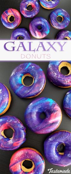 galaxy donuts with purple and blue glazes are displayed on a black surface