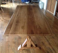 a wooden table sitting on top of a hard wood floor